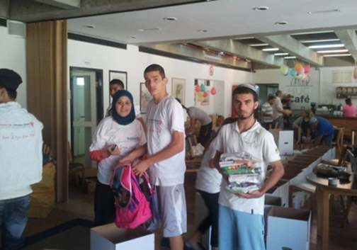 Jewish and Gypsy youth working together making Back-to-School packages